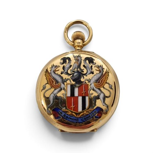 fig 1. An 18-karat gold Victorian pocket watch casing displaying a polychrome enamelled coat of arms flanked by griffin supporters and a heraldic motto banner.