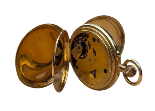fig 5. An 18-karat gold Victorian pocket watch casing displaying a polychrome enamelled coat of arms flanked by griffin supporters and a heraldic motto banner.