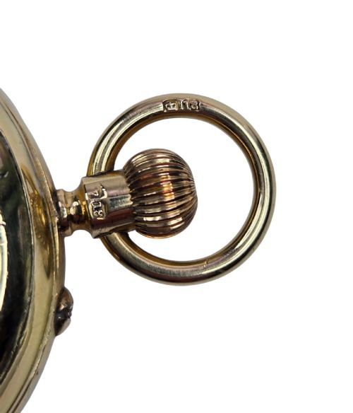 fig 7. An 18-karat gold Victorian pocket watch casing displaying a polychrome enamelled coat of arms flanked by griffin supporters and a heraldic motto banner.