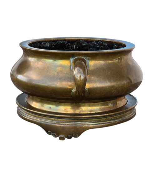 fig 1. A heavy Chinese bronze ritual censer featuring twin loop handles and resting on a matching fitted base with shaped feet.