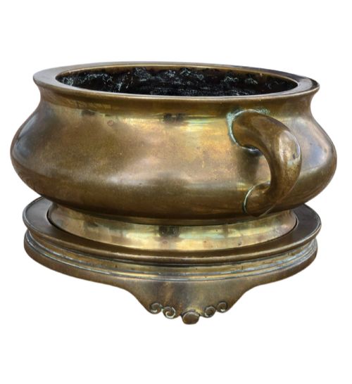 fig 3. A heavy Chinese bronze ritual censer featuring twin loop handles and resting on a matching fitted base with shaped feet.