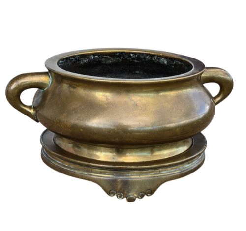 fig 5. A heavy Chinese bronze ritual censer featuring twin loop handles and resting on a matching fitted base with shaped feet.