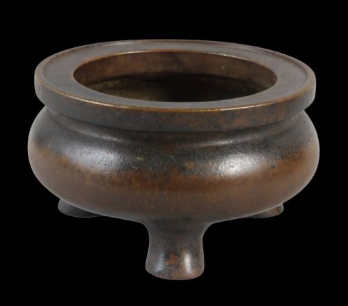 fig 1. A heavy 17th-century Chinese archaistic bronze tripod censer featuring a compressed globular body, wide flat rim, dark brown patina, and three sturdy feet.