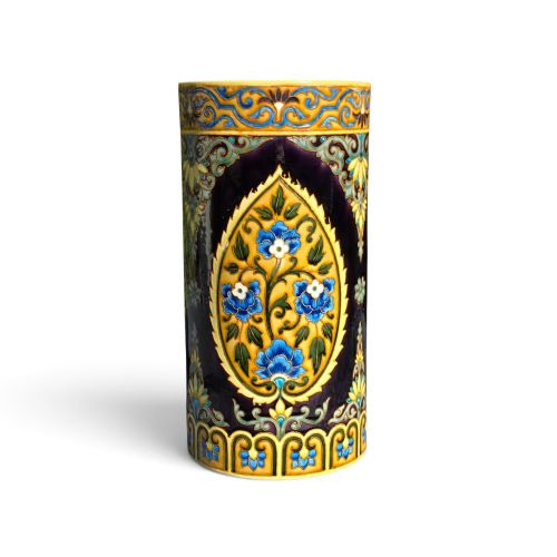 fig 1. A tall cylindrical ceramic umbrella stand decorated with colourful Iznik-style floral medallions, turquoise scrolling foliage, and a deep purple glazed background.