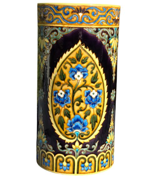 fig 3. A tall cylindrical ceramic umbrella stand decorated with colourful Iznik-style floral medallions, turquoise scrolling foliage, and a deep purple glazed background.