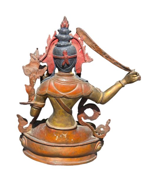 fig 5. An antique Sino-Tibetan gilt-bronze figure of Bodhisattva Manjushri seated cross-legged on a double-lotus base, brandishing a flaming sword in his right hand.