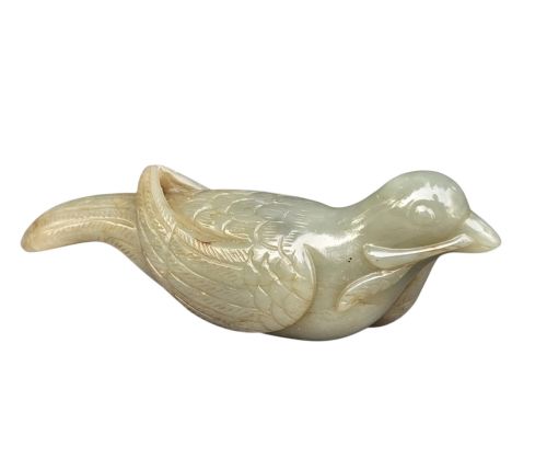 fig 1. A carved celadon jade figure depicting a resting water bird holding a leafy stem in its beak.