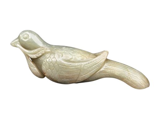 fig 3. A carved celadon jade figure depicting a resting water bird holding a leafy stem in its beak.