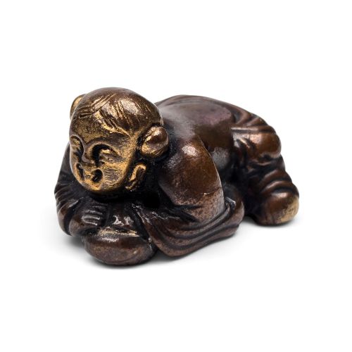 A Rare Solid-cast Bronze and Selectively Fire-gilded Figural Scholar’s Desk Paperweight (Zhenzhi) in the Form of a Reclining Boy (Wa Wa)  Ming Dynasty, 16th Century