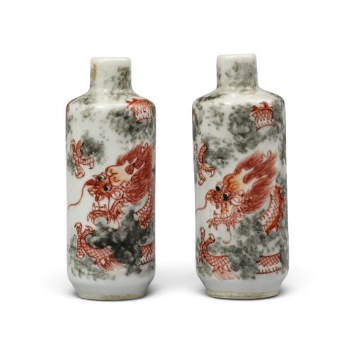A Fine Matched Pair of Guangxu-period Porcelain Snuff Bottles Decorated in Iron-red with Clawed Dragons Amidst Vaporous Clouds, Late 19th Century.