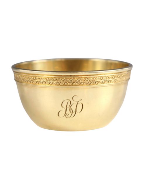 fig 2. A circular gold silver-gilt presentation bowl featuring an engraved monogram and a carved leaf border near the upper rim.