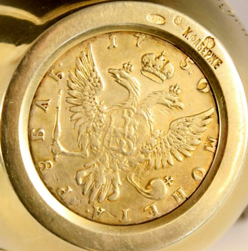 fig 6. A circular gold silver-gilt presentation bowl featuring an engraved monogram and a carved leaf border near the upper rim.