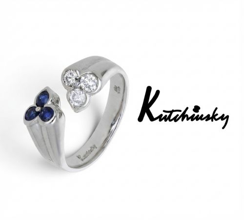 fig 1. A mid-century 18ct white gold crossover ring features opposing trefoil terminals set with blue sapphires and brilliant-cut diamonds.