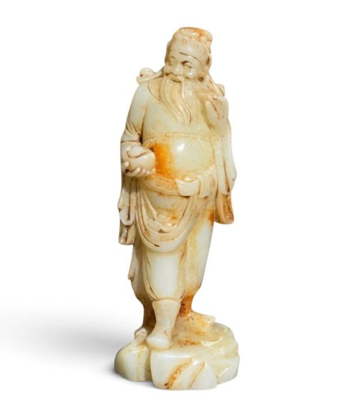 A Substantial Ming Dynasty Pale Celadon and Russet Nephrite Jade Figural Carving of an Immortal