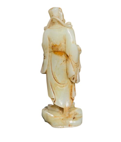 fig 4. A carved pale celadon and russet nephrite jade standing figure of an immortal holding a vessel on a carved rockwork base.