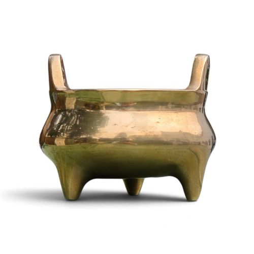 fig 1. A miniature cast bronze tripod censer featuring loop handles, conical legs, and natural surface patination.