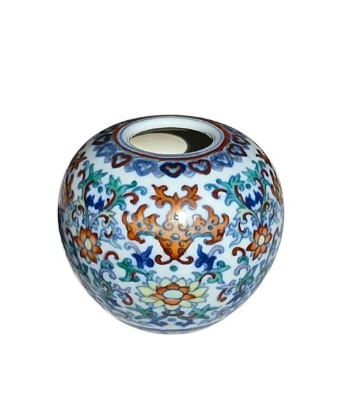 fig 2. A rounded Chinese porcelain water pot decorated in doucai enamels with lotus flowers, bats, and scrolling foliage.
