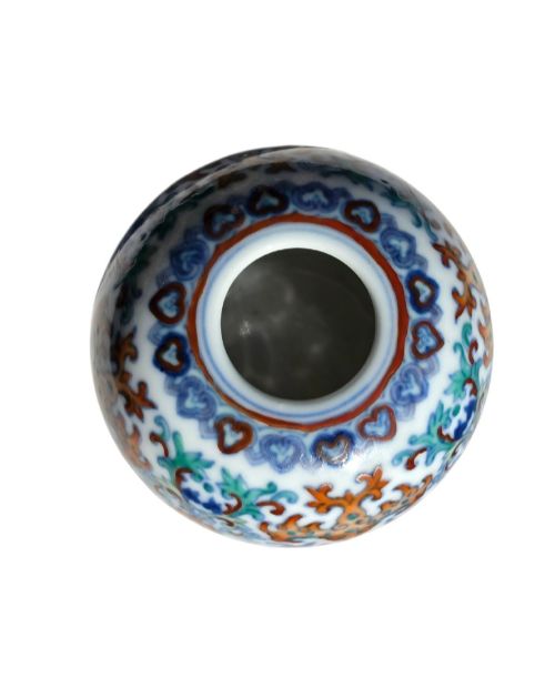 fig 3. A rounded Chinese porcelain water pot decorated in doucai enamels with lotus flowers, bats, and scrolling foliage.