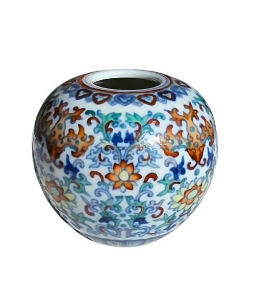 fig 4. A rounded Chinese porcelain water pot decorated in doucai enamels with lotus flowers, bats, and scrolling foliage.