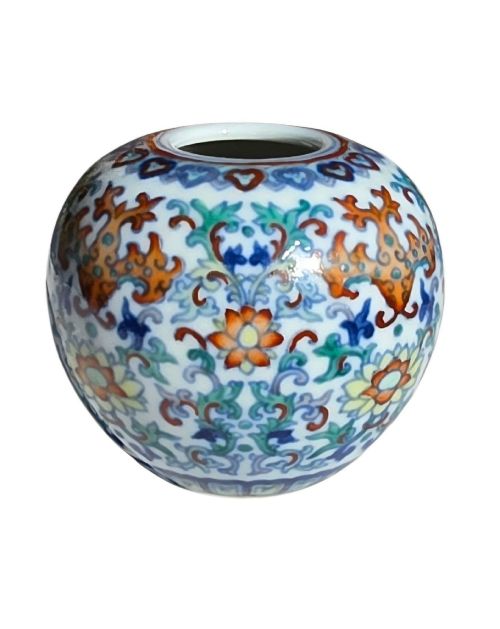 fig 6. A rounded Chinese porcelain water pot decorated in doucai enamels with lotus flowers, bats, and scrolling foliage.