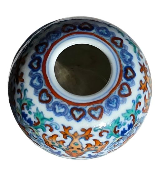 fig 9. A rounded Chinese porcelain water pot decorated in doucai enamels with lotus flowers, bats, and scrolling foliage.