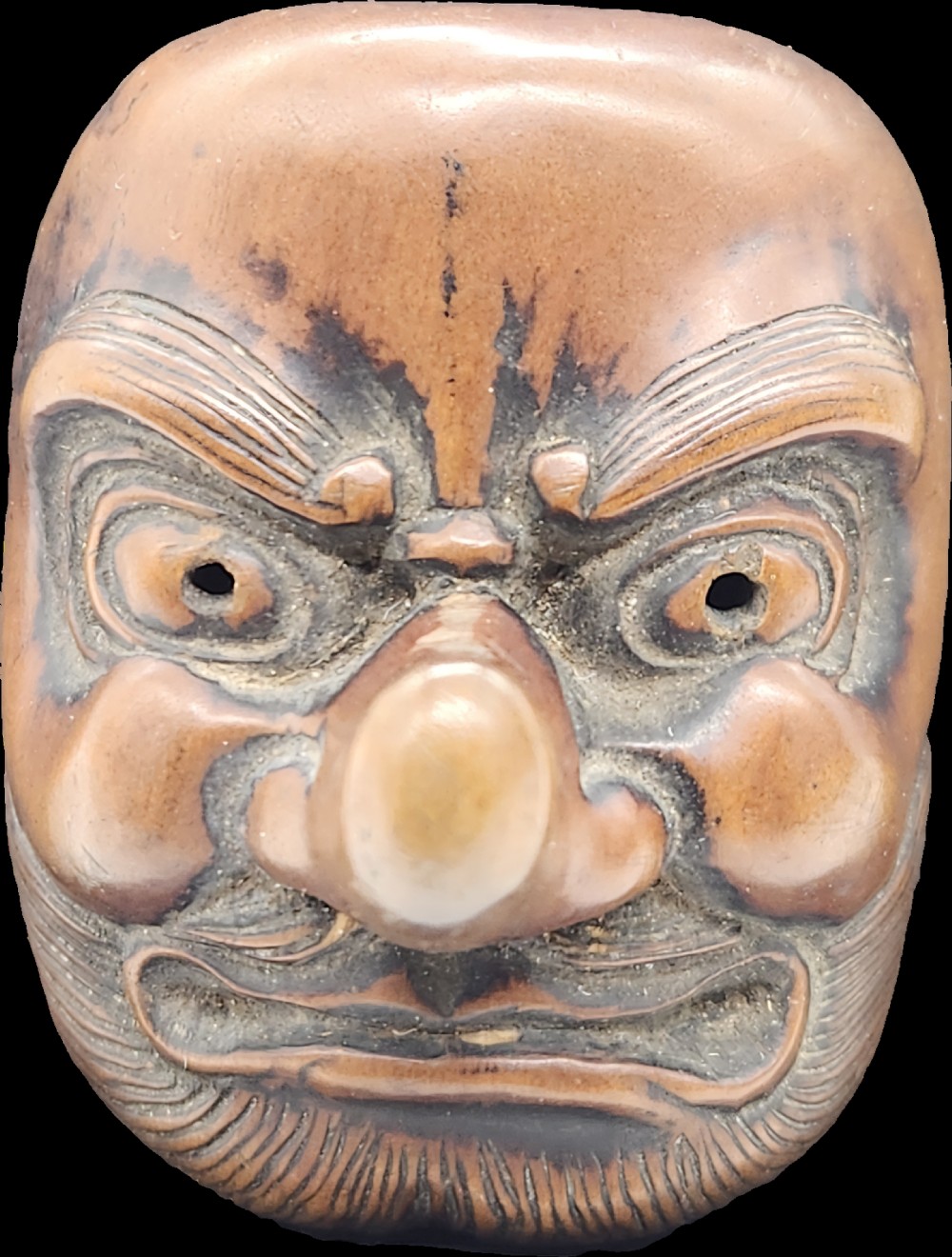 AN AMUSING WOOD MASK NETSUKE OF A LONG-NOSED TENGU EDO PERIOD View II