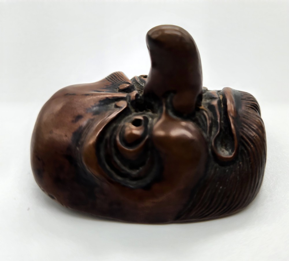 AN AMUSING WOOD MASK NETSUKE OF A LONG-NOSED TENGU EDO PERIOD View V