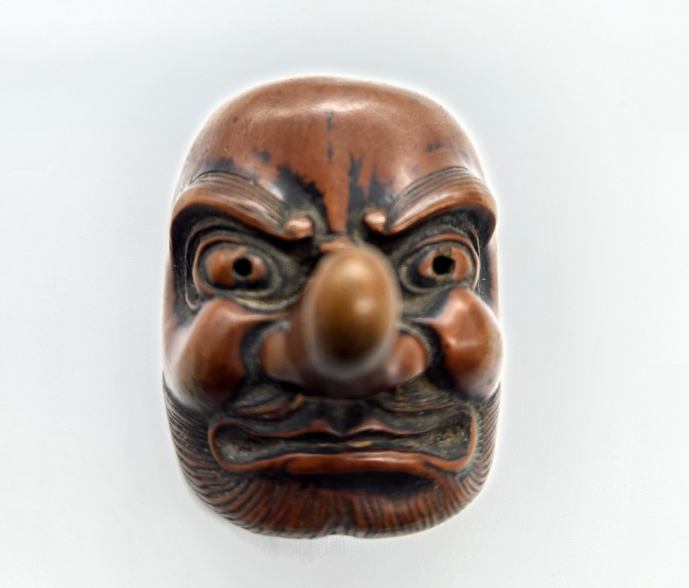 AN AMUSING WOOD MASK NETSUKE OF A LONG-NOSED TENGU EDO PERIOD View VI