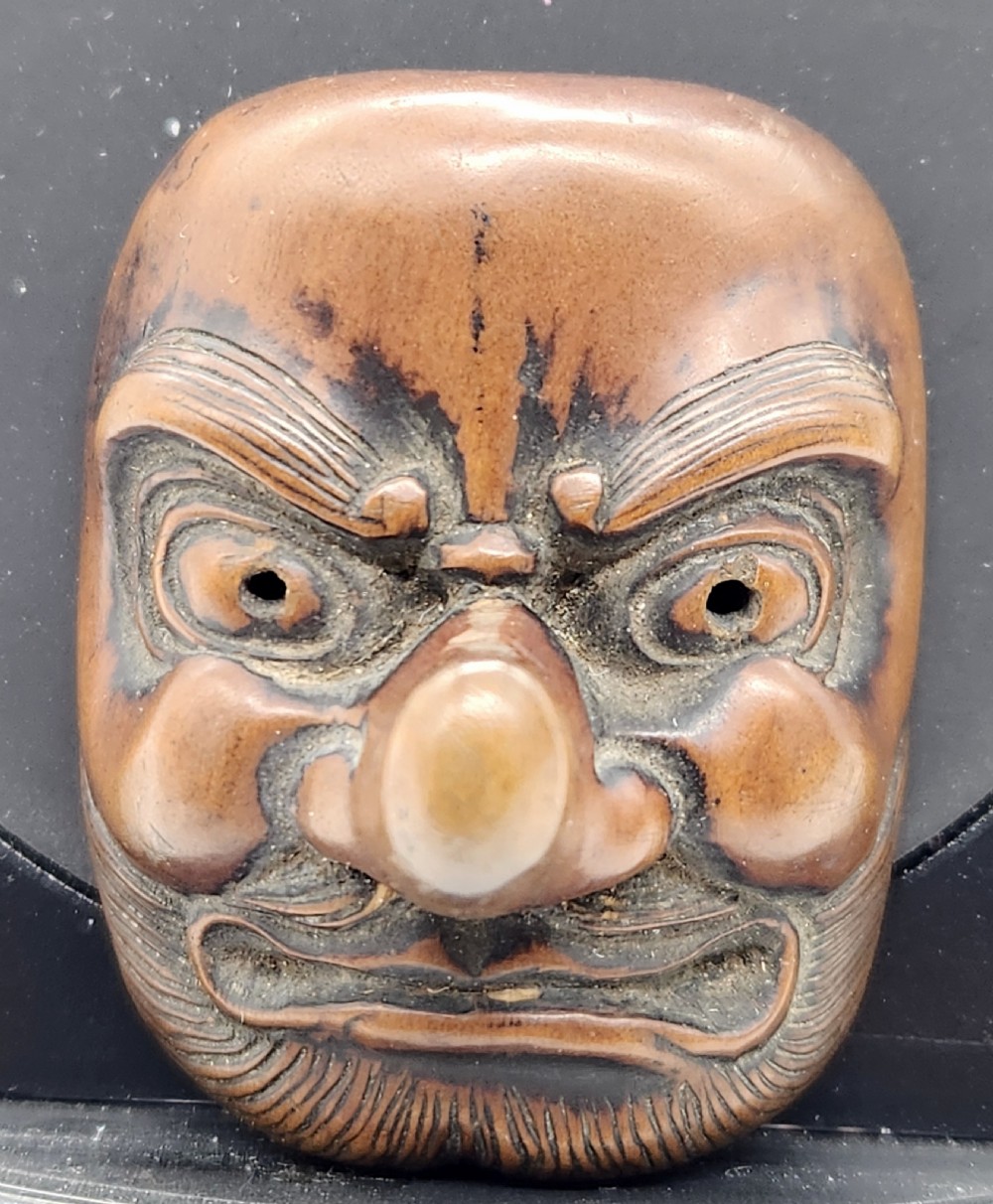 AN AMUSING WOOD MASK NETSUKE OF A LONG-NOSED TENGU EDO PERIOD View VII