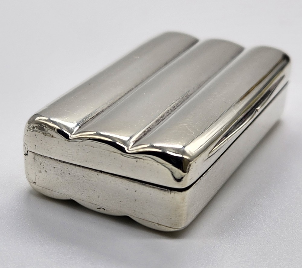 A small rectangular Georgian sterling silver snuff box featuring fluted channels on the cover and a polished silver finish. View VII