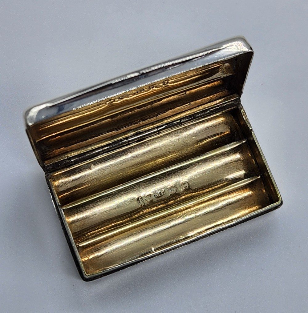 A small rectangular Georgian sterling silver snuff box featuring fluted channels on the cover and a polished silver finish. View VIII