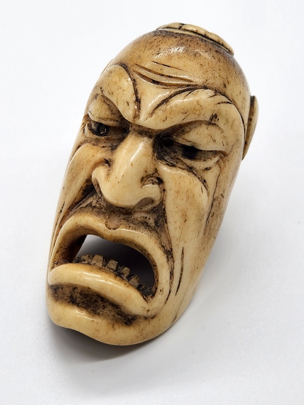 A JAPANESE EDO PERIOD FINE CARVED ANTLER MASK NETSUKE OF HANNYA 