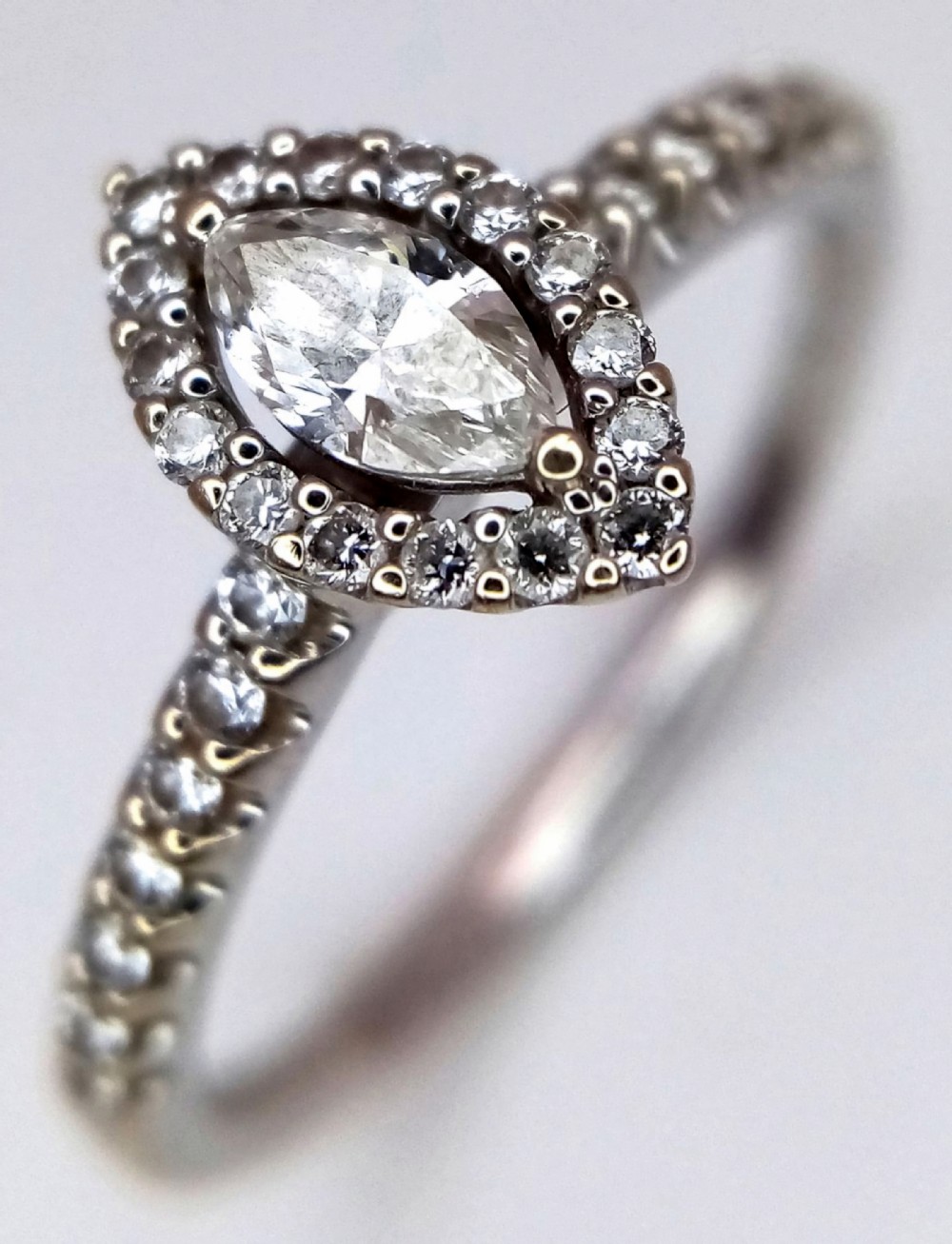 An 18K Gold And Marquise Cut Diamond Cluster Ring 