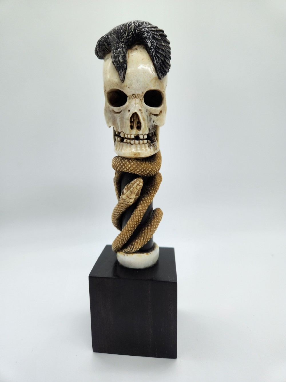 A Rare Japanese Okimono Meiji Period Carving of A Skull With a Feathered Bird Entwined By A Snake 