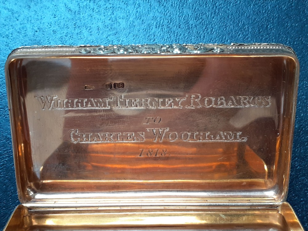 A rectangular 18 carat gold snuff box featuring engine-turned panels surrounded by a chased foliate border. View VII