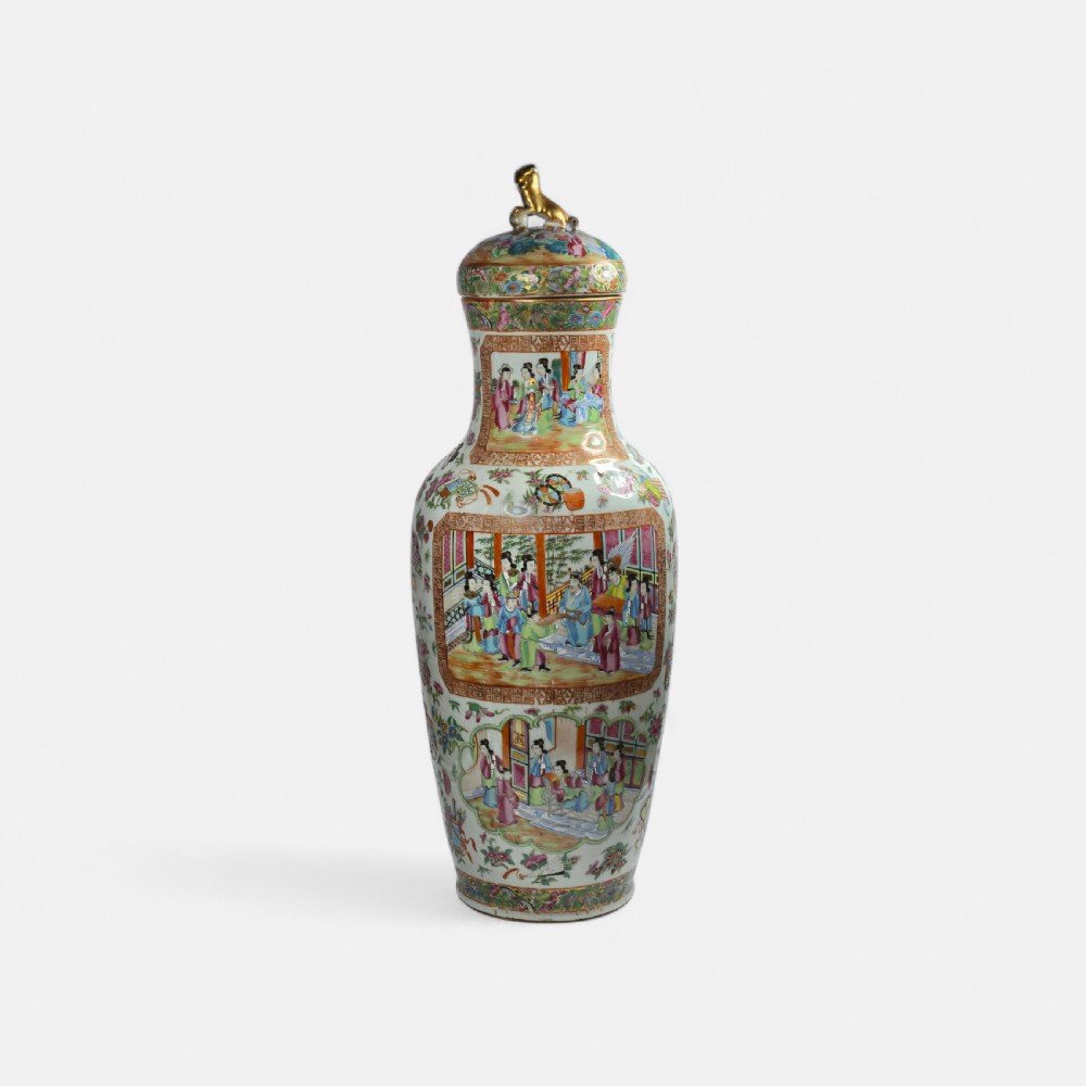 A 19th-century Cantonese Rose Mandarin porcelain baluster vase decorated with narrative figure panels, floral enamel borders, and a domed cover topped with a gilt foo dog finial. View III
