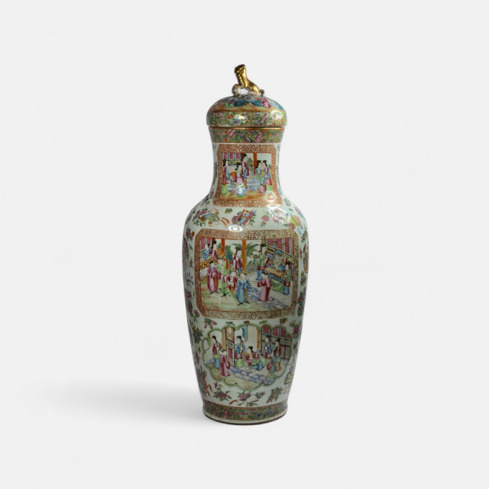A 19th-century Cantonese Rose Mandarin porcelain baluster vase decorated with narrative figure panels, floral enamel borders, and a domed cover topped with a gilt foo dog finial. View IV