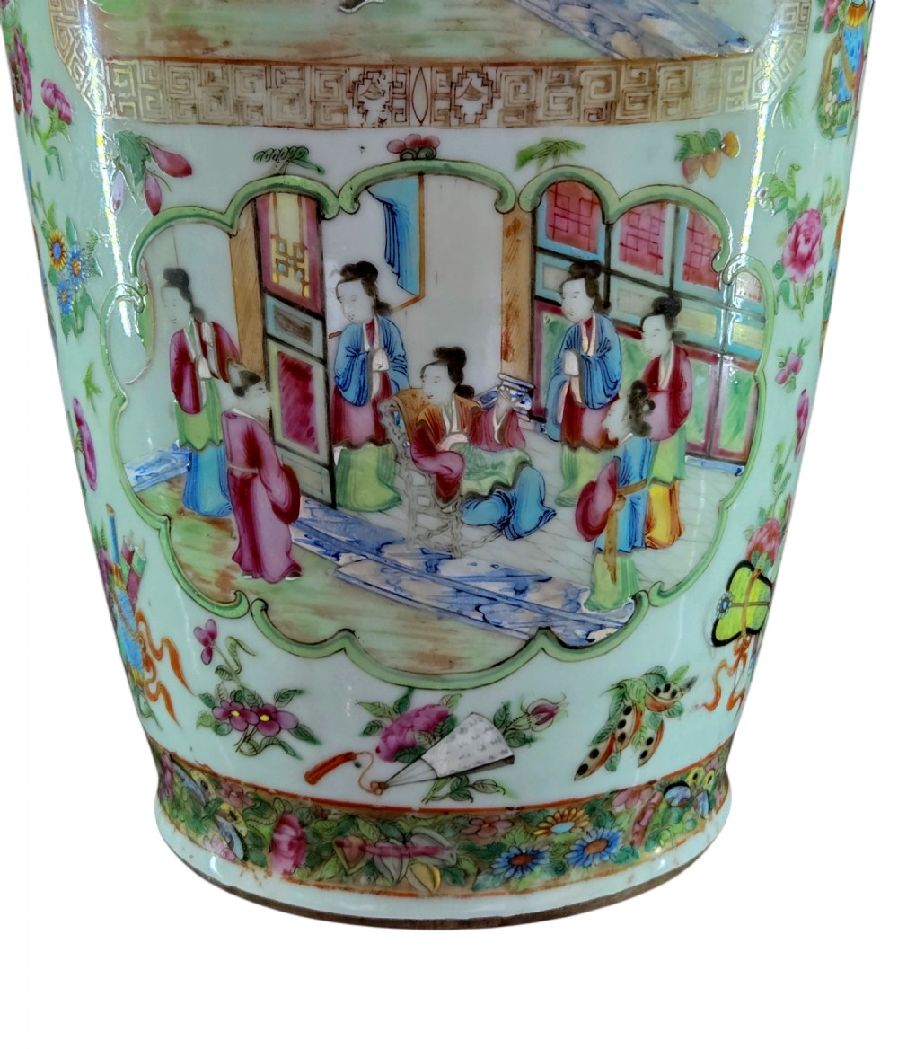 A 19th-century Cantonese Rose Mandarin porcelain baluster vase decorated with narrative figure panels, floral enamel borders, and a domed cover topped with a gilt foo dog finial. View VI