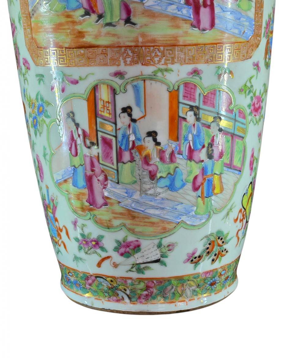 A 19th-century Cantonese Rose Mandarin porcelain baluster vase decorated with narrative figure panels, floral enamel borders, and a domed cover topped with a gilt foo dog finial. View VII