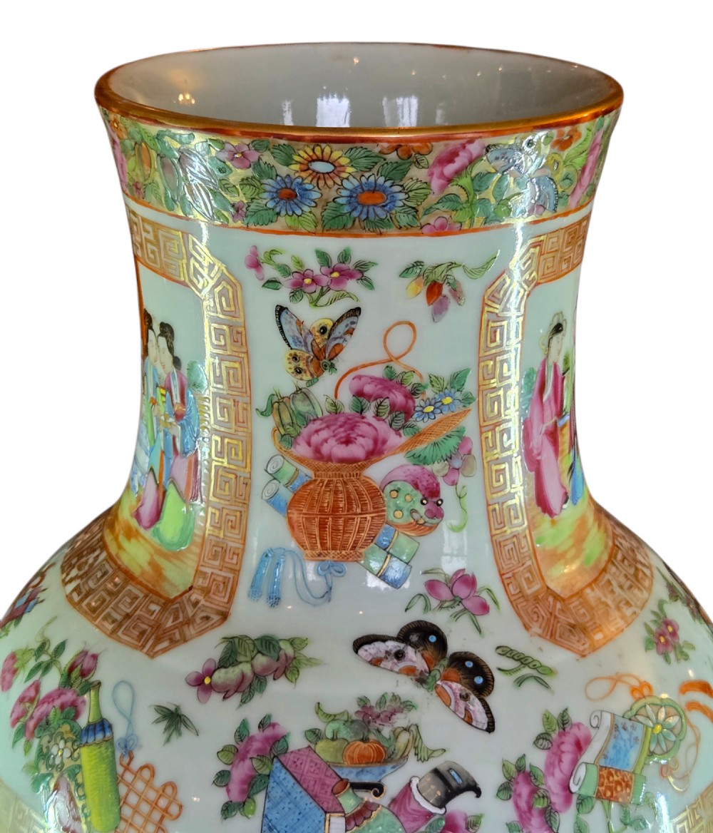 A 19th-century Cantonese Rose Mandarin porcelain baluster vase decorated with narrative figure panels, floral enamel borders, and a domed cover topped with a gilt foo dog finial. View X