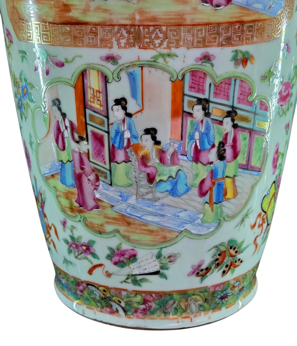 A 19th-century Cantonese Rose Mandarin porcelain baluster vase decorated with narrative figure panels, floral enamel borders, and a domed cover topped with a gilt foo dog finial. View XV