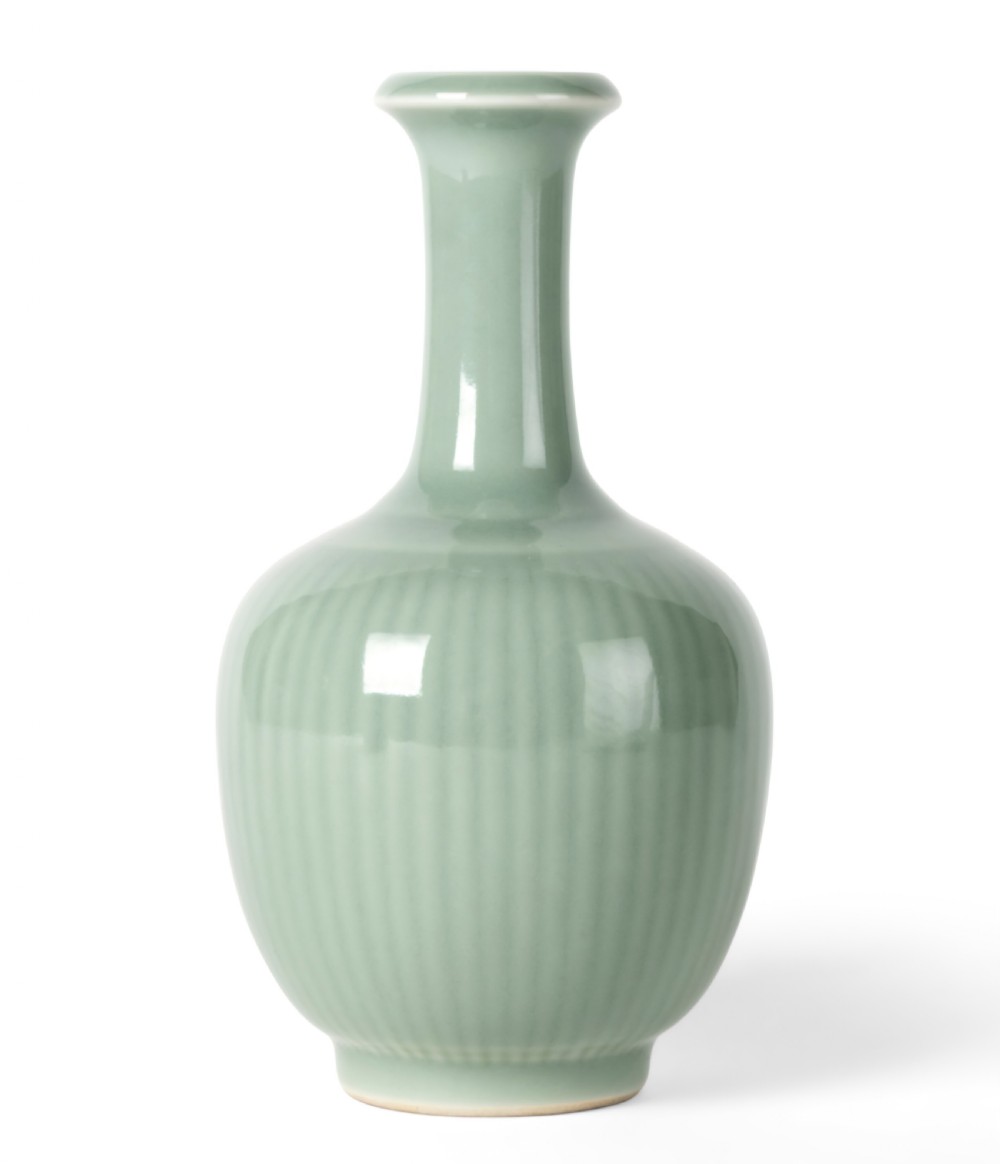 A Qing dynasty celadon-glazed porcelain bottle vase with vertical fluting on the body and a tall slender neck. View III