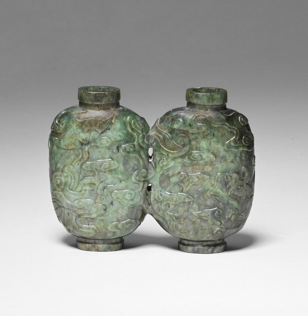 A carved double-lobed spinach-green jade snuff bottle decorated with raised cloud motifs and twin cylindrical rims.