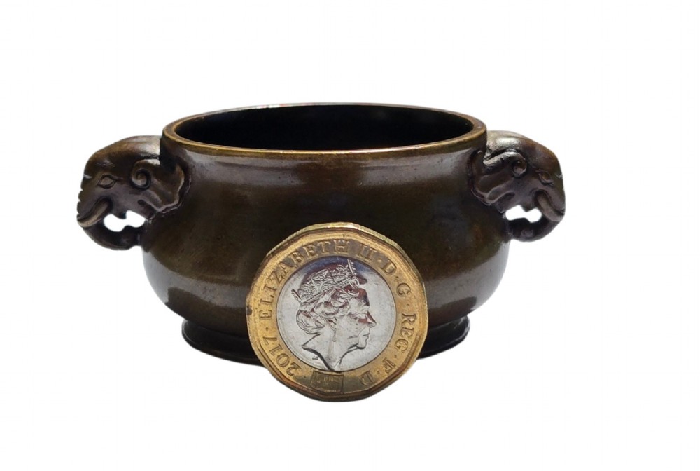 A miniature dark bronze censer featuring a rounded body, twin elephant head handles with curved trunks, and a circular raised footring. View II