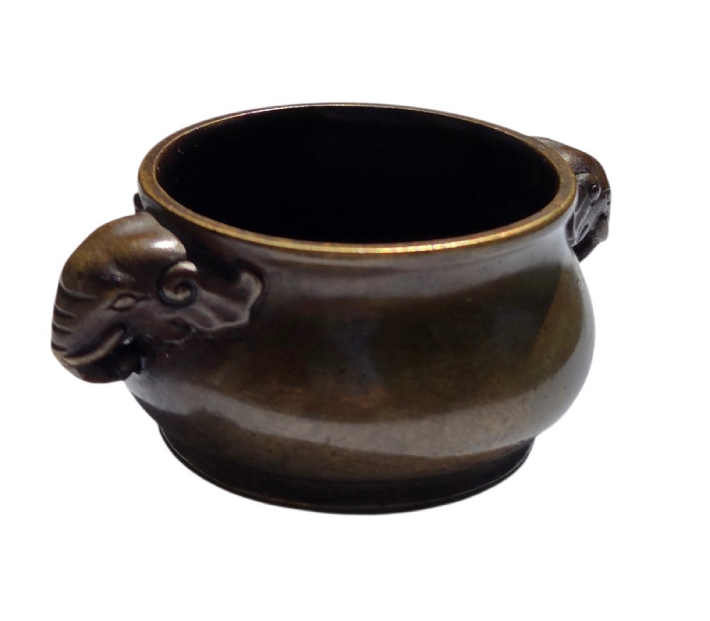A miniature dark bronze censer featuring a rounded body, twin elephant head handles with curved trunks, and a circular raised footring. View III