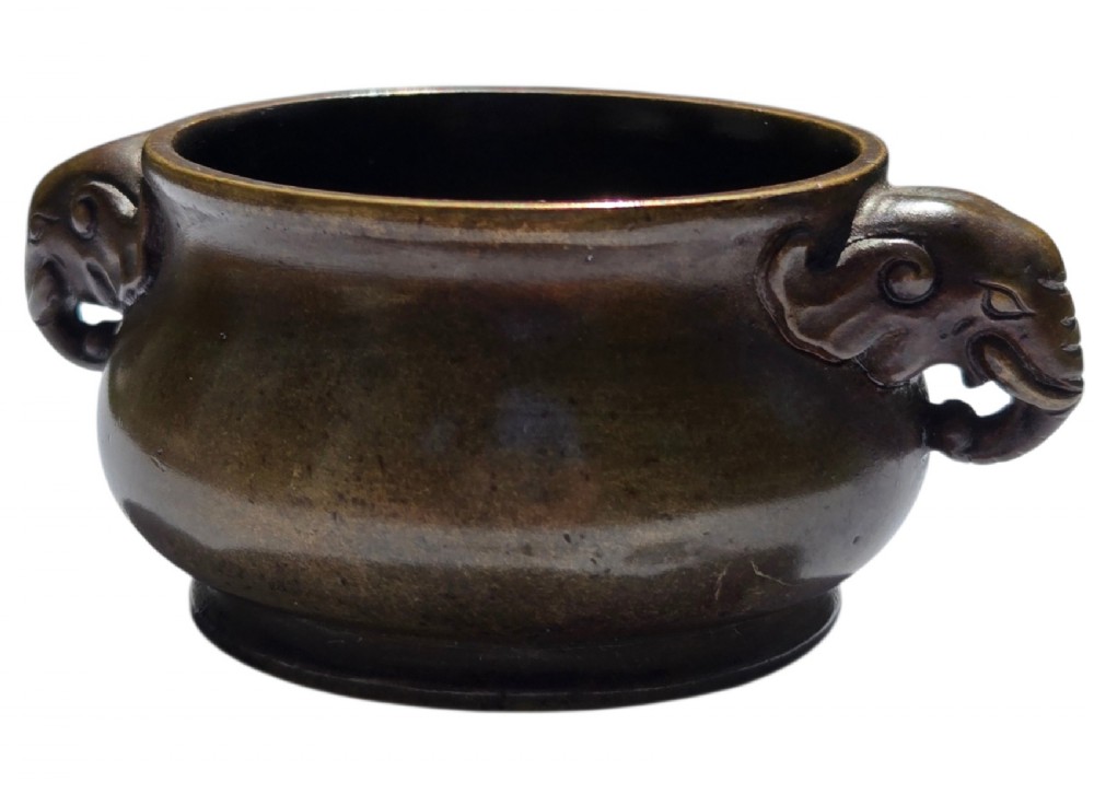 A miniature dark bronze censer featuring a rounded body, twin elephant head handles with curved trunks, and a circular raised footring. View IX