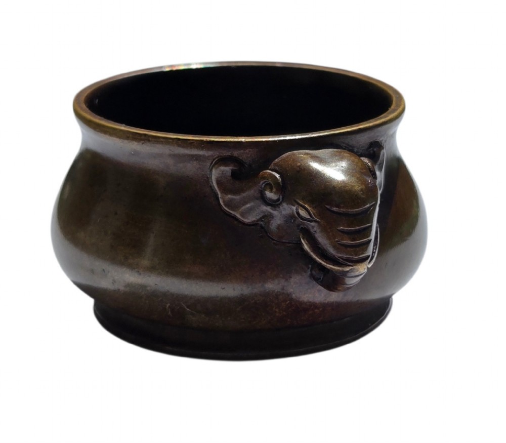 A miniature dark bronze censer featuring a rounded body, twin elephant head handles with curved trunks, and a circular raised footring. View X