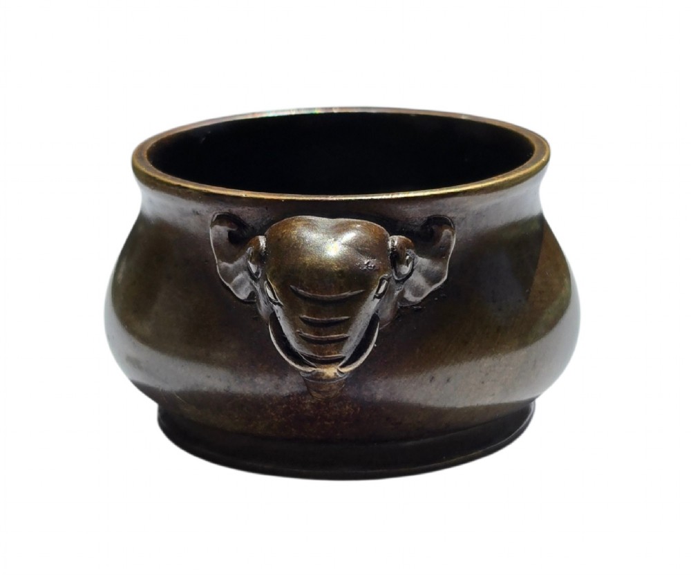 A miniature dark bronze censer featuring a rounded body, twin elephant head handles with curved trunks, and a circular raised footring. View XI