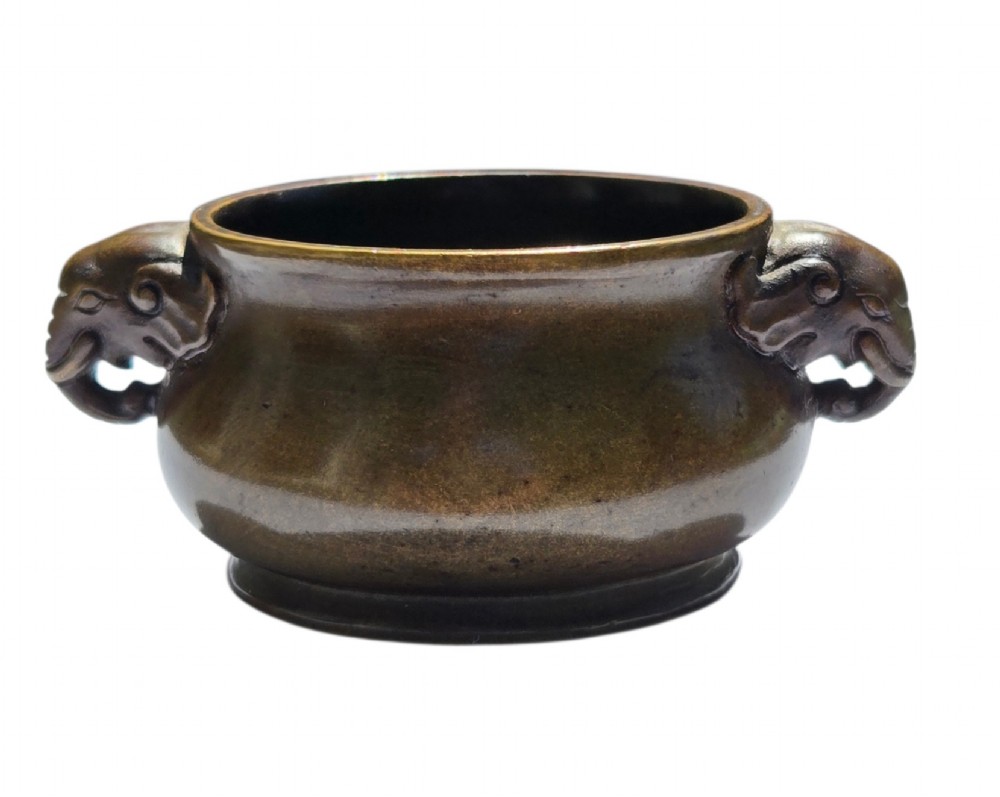 A miniature dark bronze censer featuring a rounded body, twin elephant head handles with curved trunks, and a circular raised footring. View XIII