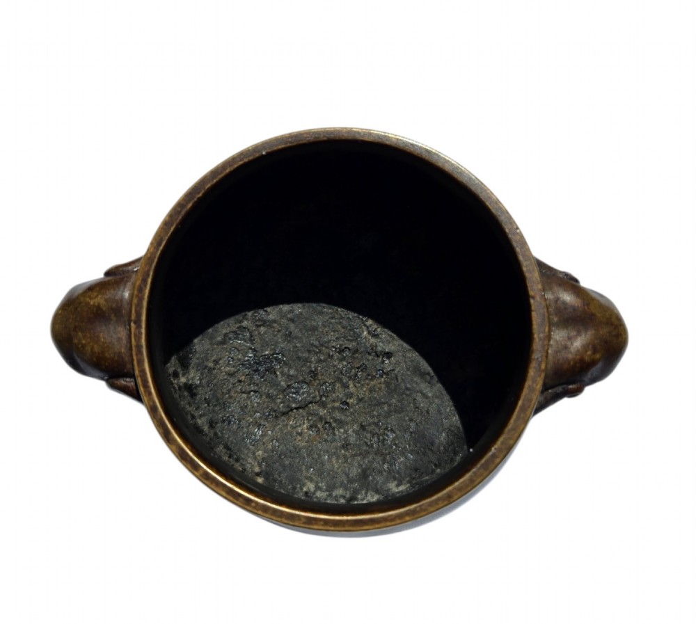 A miniature dark bronze censer featuring a rounded body, twin elephant head handles with curved trunks, and a circular raised footring. View XIV